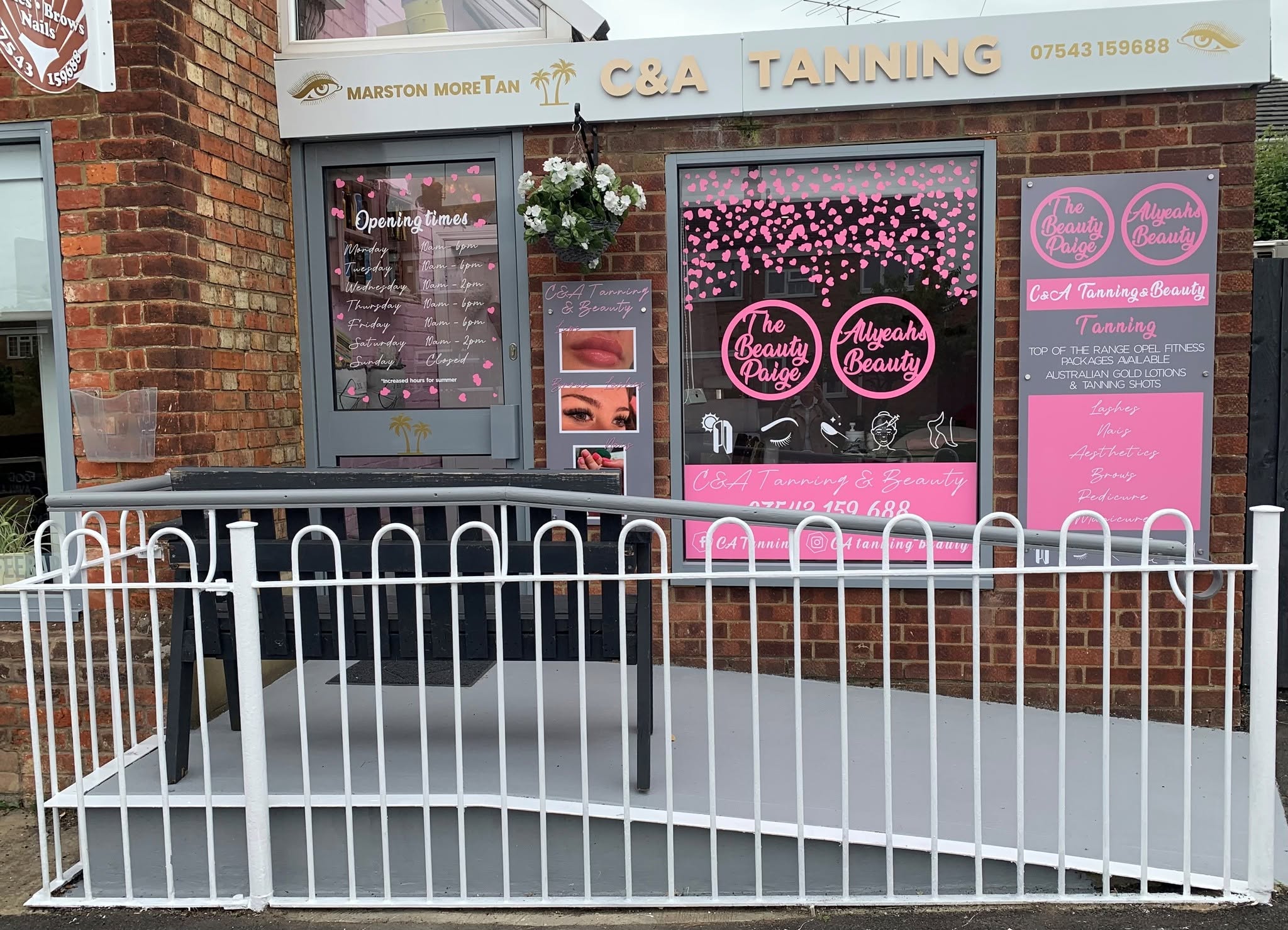 The C&A Tanning shopfront in Marston Moretaine, with gold lettering on a white fascia.