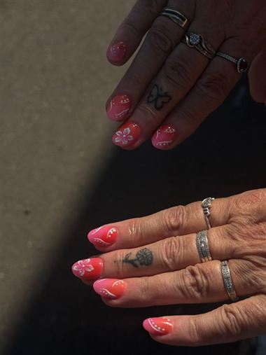 Pink nails with hand-painted detail.