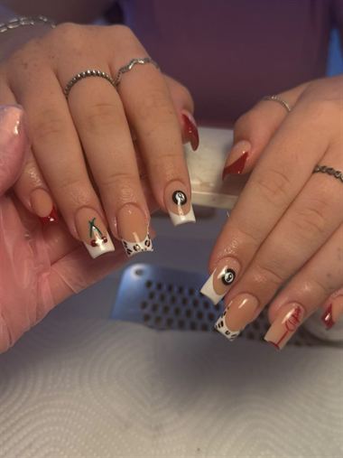Nude nails with black and white tip designs.
