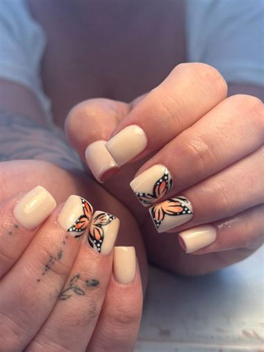 Short square nails with orange butterflies.